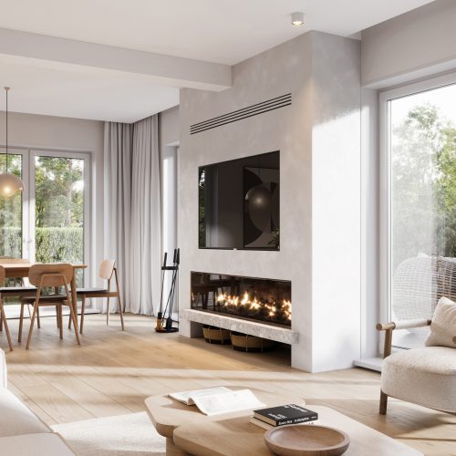 Modern living and dining room with large windows, light wood floors, neutral furniture, a cozy armchair, a fireplace below a wall-mounted TV, and a dining table with pendant lights; trees visible outside.